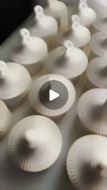 Rows of freshly cast lidded concrete jars
